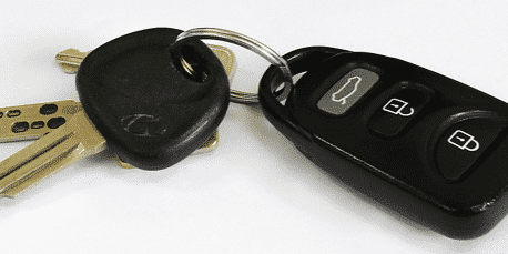 A group of car keys, car key fobs, and car remotes. 