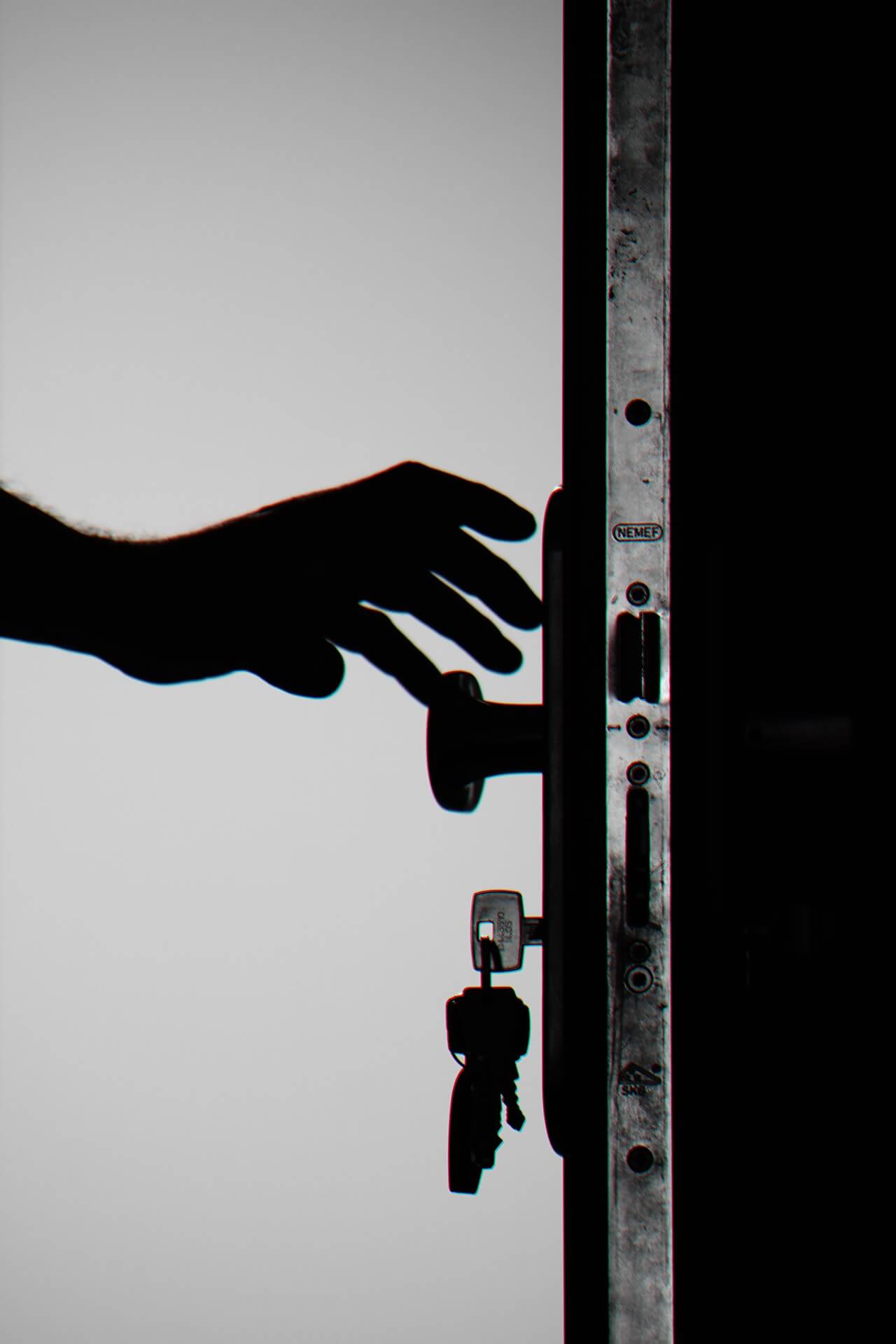 A man opening a door with a key.